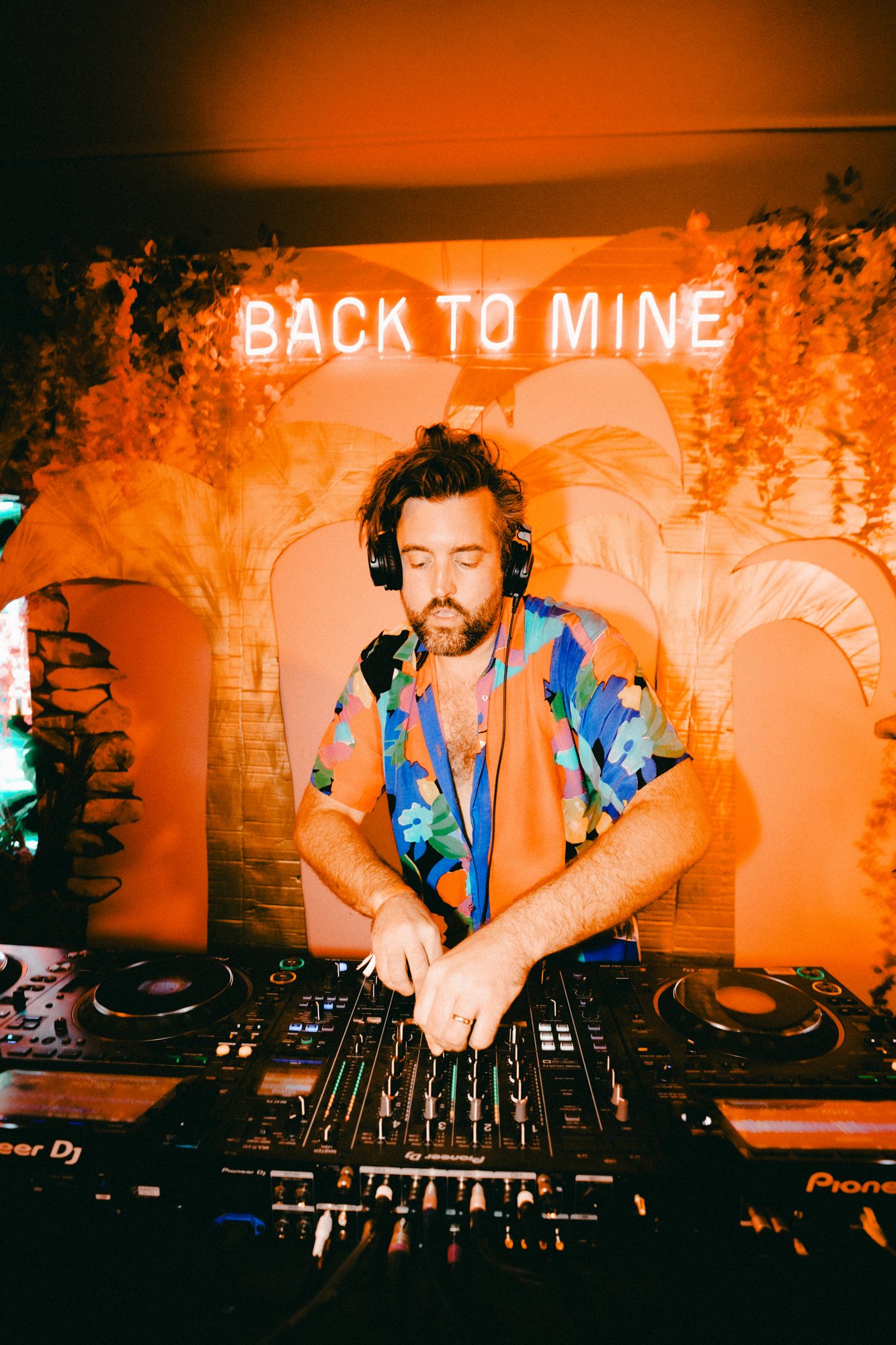 Sir Francis on the decks under neon at a party